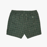 A pair of swim shorts in dark green with a repeating light green palm tree pattern, featuring a buttoned side pocket and drawstring waist