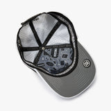 An overhead view of a gray snapback cap with a black brim, black mesh back panels, and a black adjustable strap. The inside of the cap features a detailed graphic print with the text 'MAKE YOUR BACK' and a circular logo on the brim.