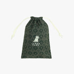 A dark green drawstring pouch with a repeating palm tree pattern and a white 'JAMES BARK' dog logo printed on the front
