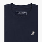 A folded black crewneck t-shirt by James Bark, featuring a white graphic of a dog wearing a crown