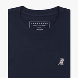 A folded black crewneck t-shirt by James Bark, featuring a white graphic of a dog wearing a crown