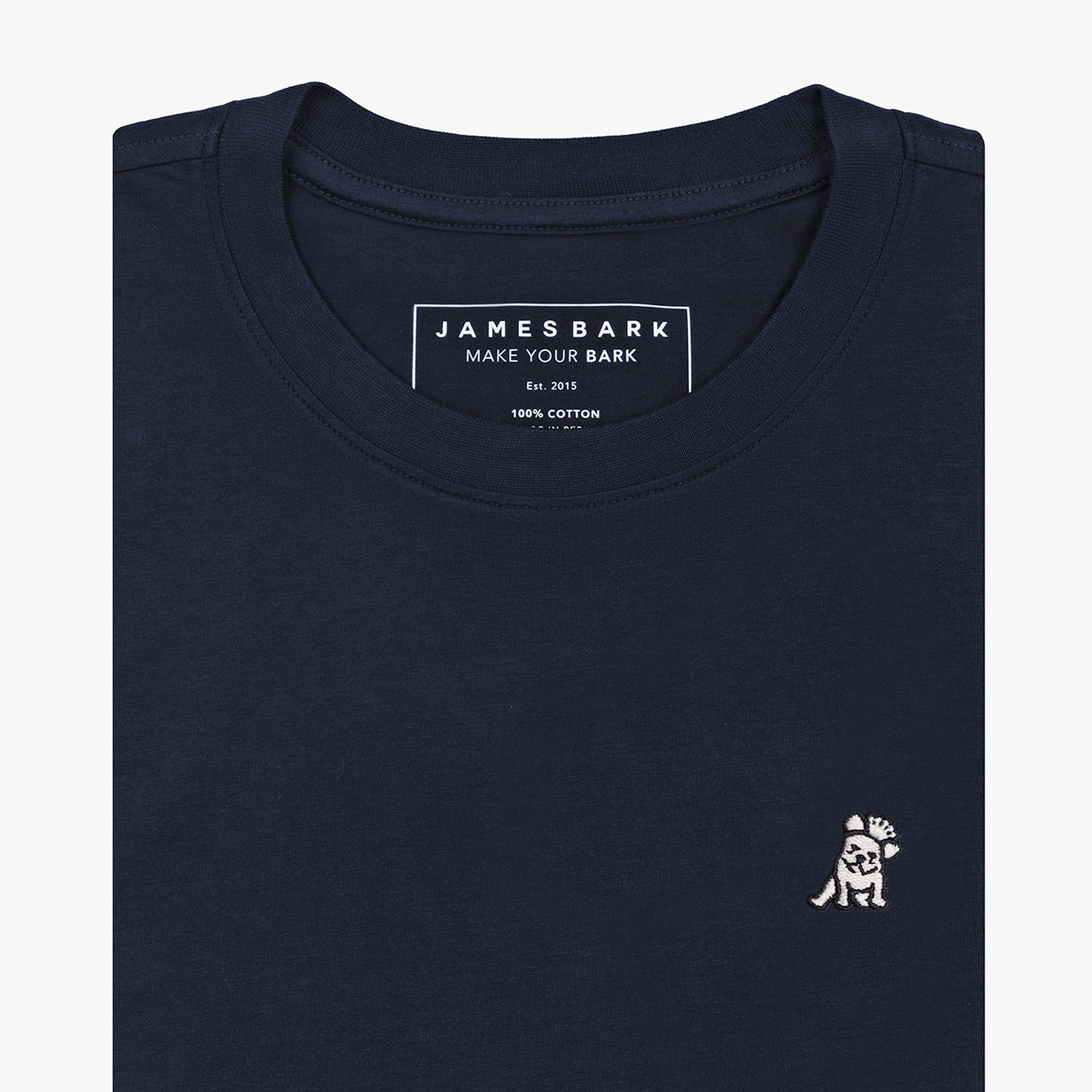 A folded black crewneck t-shirt by James Bark, featuring a white graphic of a dog wearing a crown