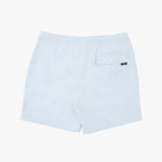 Light blue swim shorts with an elastic waistband, a side pocket with a snap button, and a small black brand tag