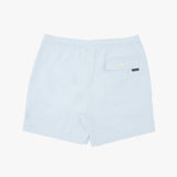 Light blue swim shorts with an elastic waistband, a side pocket with a snap button, and a small black brand tag