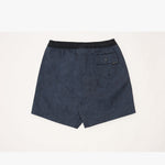 A pair of dark navy blue swim trunks with a subtle tonal pattern, featuring a black elastic waistband and a side pocket with a small black brand tag