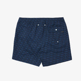 A pair of dark blue patterned swim trunks with a small white brand label on the right side, displayed flat