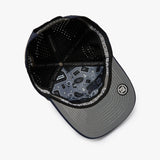 A black and gray baseball cap shown from an overhead angle, featuring a black mesh back, a gray visor with a subtle geometric pattern, and a circular patch on the side