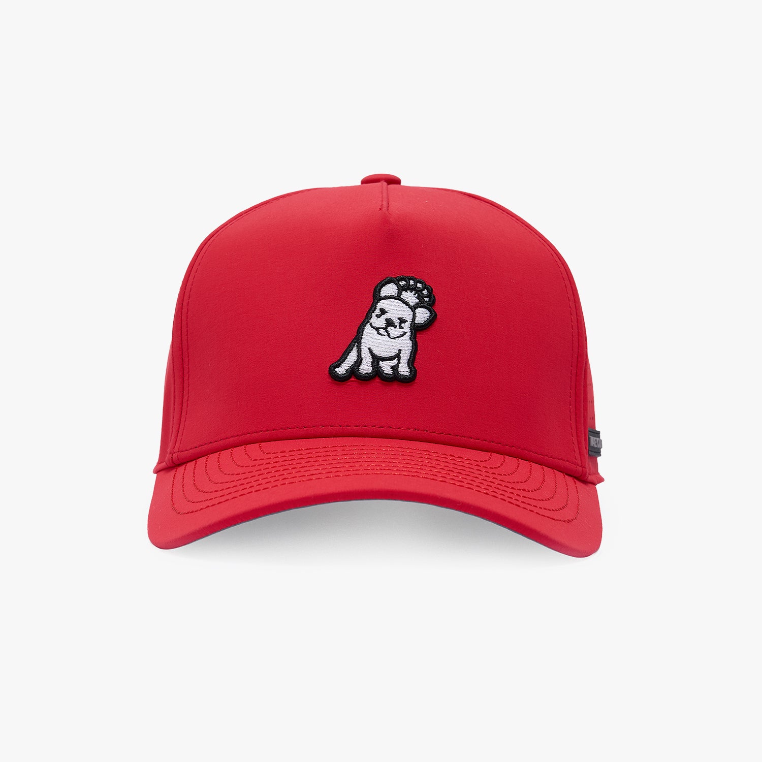 A red baseball cap featuring a small embroidered cartoon dog patch on the front