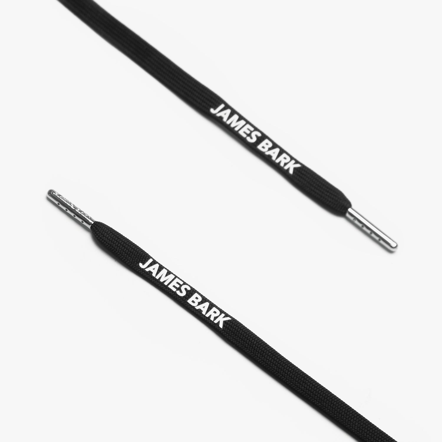 Close-up of black shoelaces with the James Bark logo