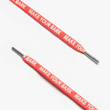 Close up of red shoelaces with the text MAKE YOUR BARK