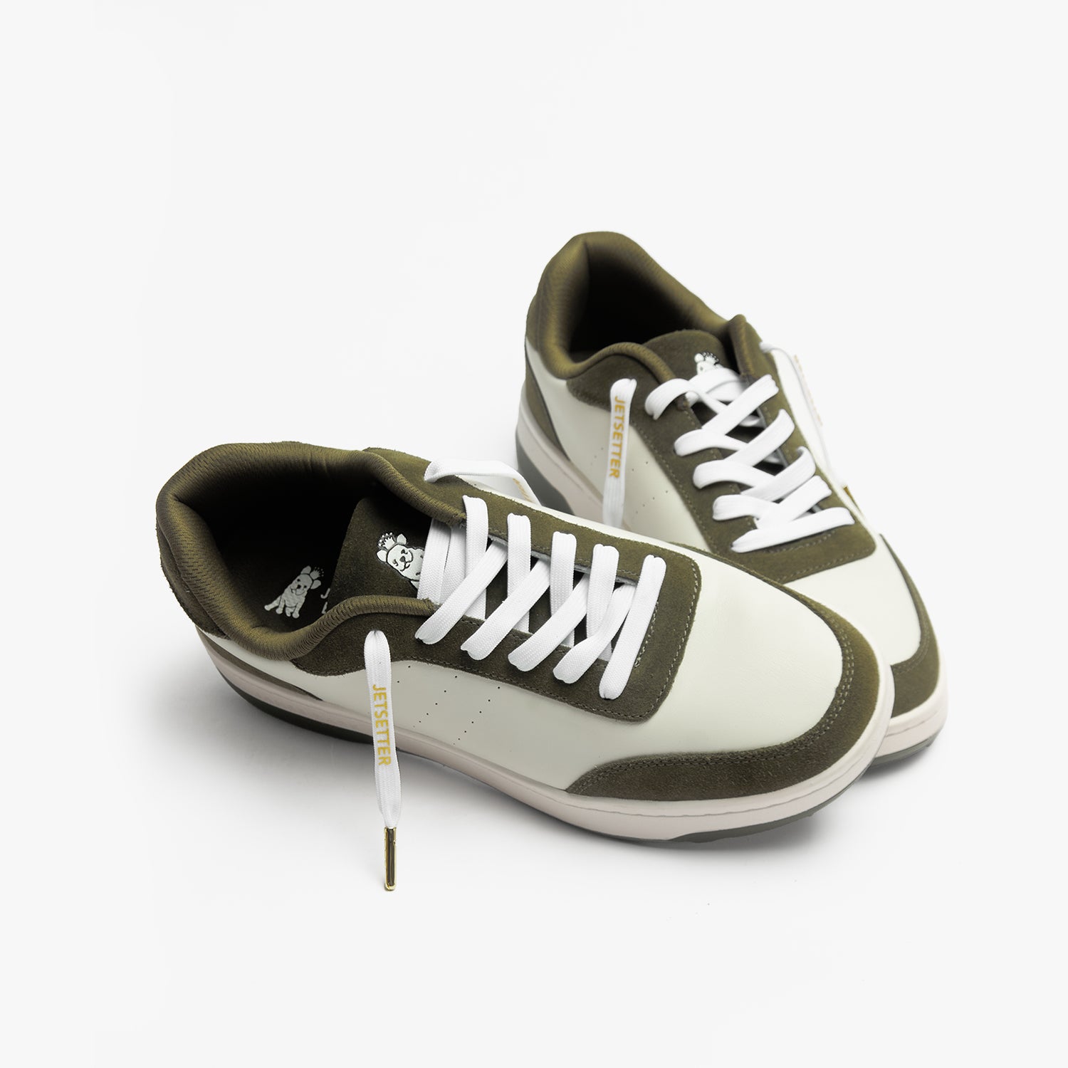 Olive green and white sneakers with white "Jetsetter" shoelaces