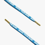 A close up of blue shoelaces displaying the text, MAKE YOUR BARK