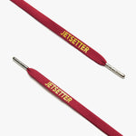 Close-up of maroon shoelaces with silver aglets and "Jetsetter" text