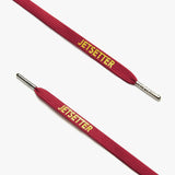 Close-up of maroon shoelaces with silver aglets and "Jetsetter" text