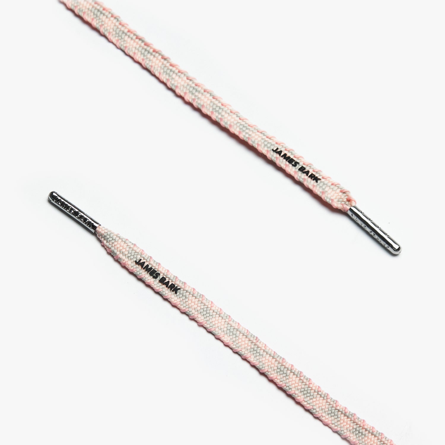 Close-up of pink and grey striped shoelaces with silver aglets and "James Bark" text