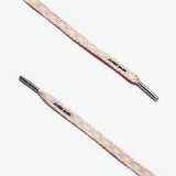 Close-up of pink and grey striped shoelaces with silver aglets and "James Bark" text