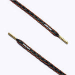Close-up of black, grey and orange patterned shoelaces with golden aglets and "James Bark" text