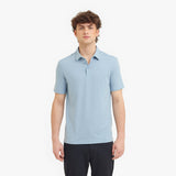 Man wearing a light blue polo shirt on a white background