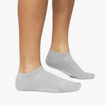 Gray ankle socks worn by a person on a white background