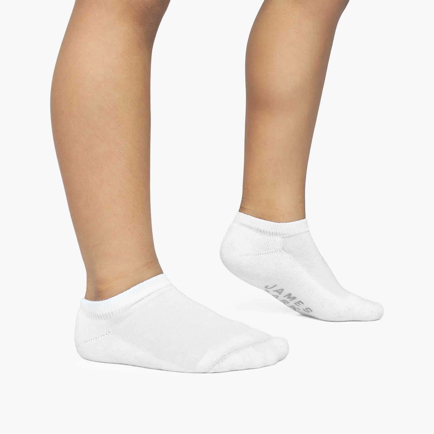 White ankle socks worn by a person on a white background