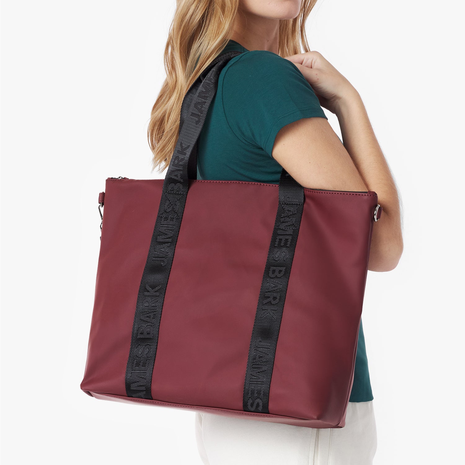 Close-up detail of the burgundy tote bag hanging on a model's shoulder