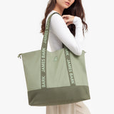 Person holding a green tote bag with 'James Bark' branding.