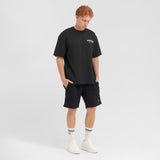 Person wearing a black t-shirt and shorts with a logo on a white background