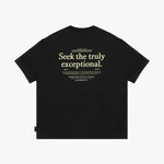 Back view of a black t-shirt laid flat, with a large "Seek the truly exceptional" graphic in off-white text