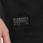Close-up of a black jacket with 'Elements' brand label.
