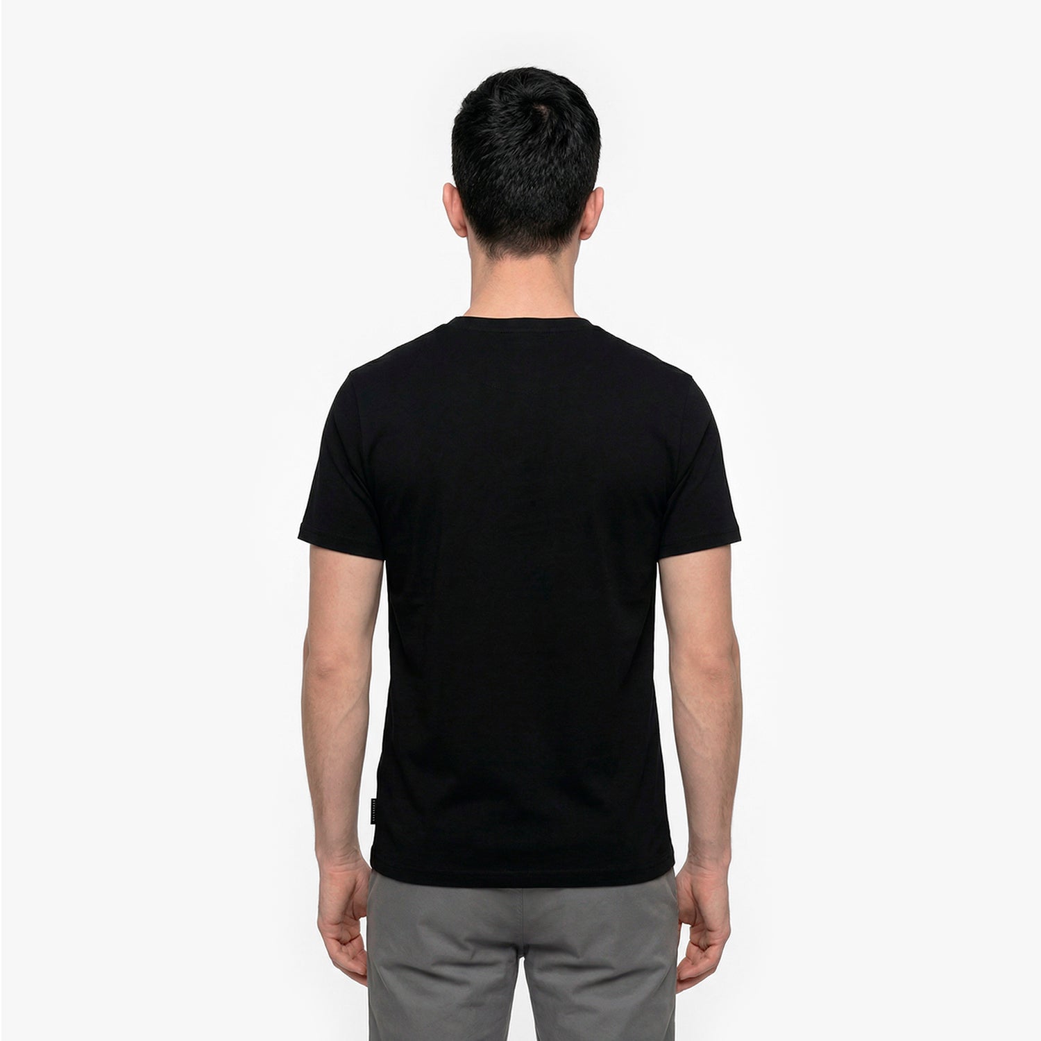Back view of a man wearing a black t-shirt on a white background