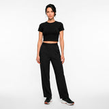 Woman wearing a black outfit on a white background