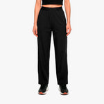 Person wearing black high-waisted pants on a white background