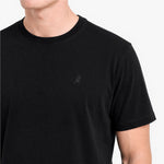 Black t-shirt with a small logo on a white background
