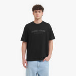 Person wearing a black t-shirt with 'James Bark Elements' text on a white background