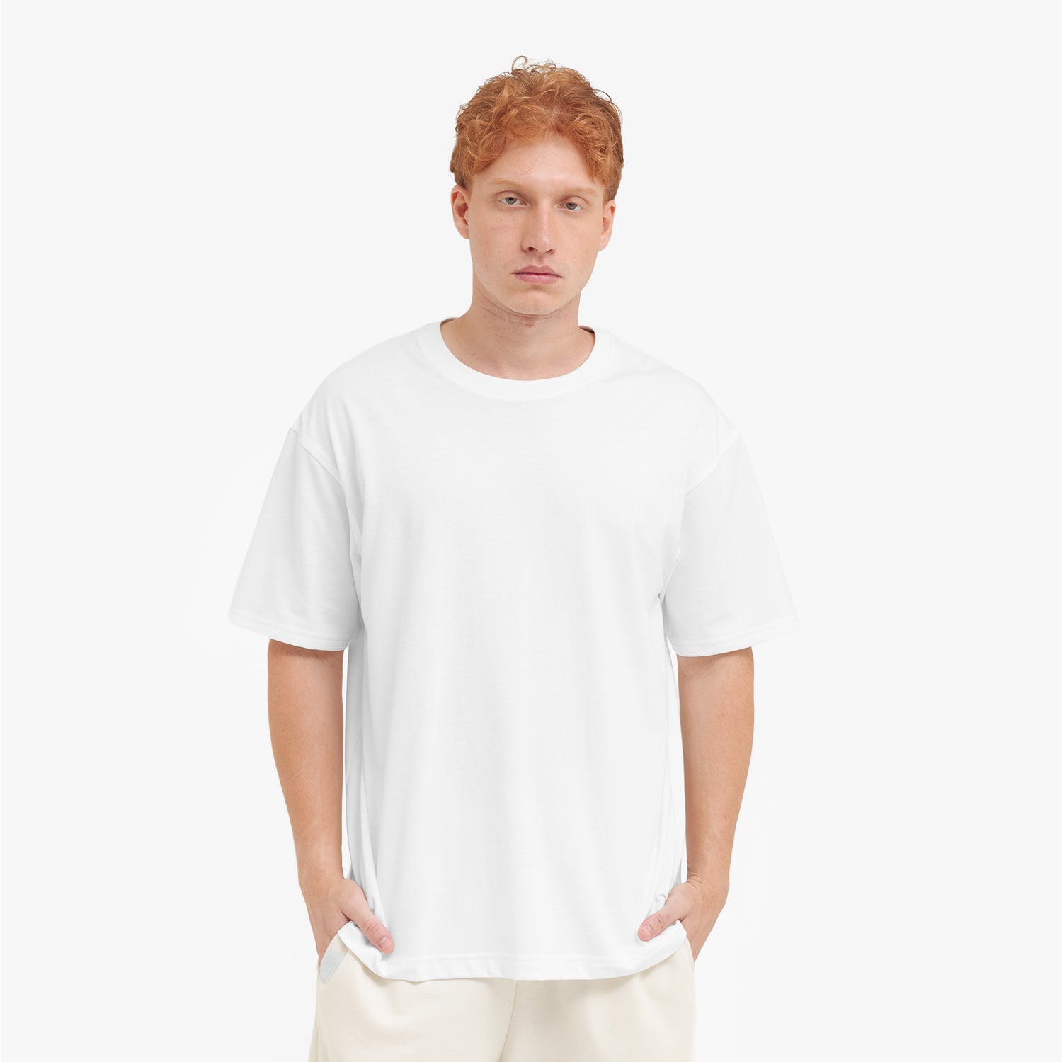 Man wearing a plain white t-shirt and pants on a white background
