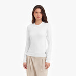 Woman wearing a white long-sleeve shirt on a white background