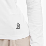Close-up of a white long-sleeve shirt with a small black logo on a white background