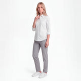 Woman wearing a white shirt and gray pants on a white background