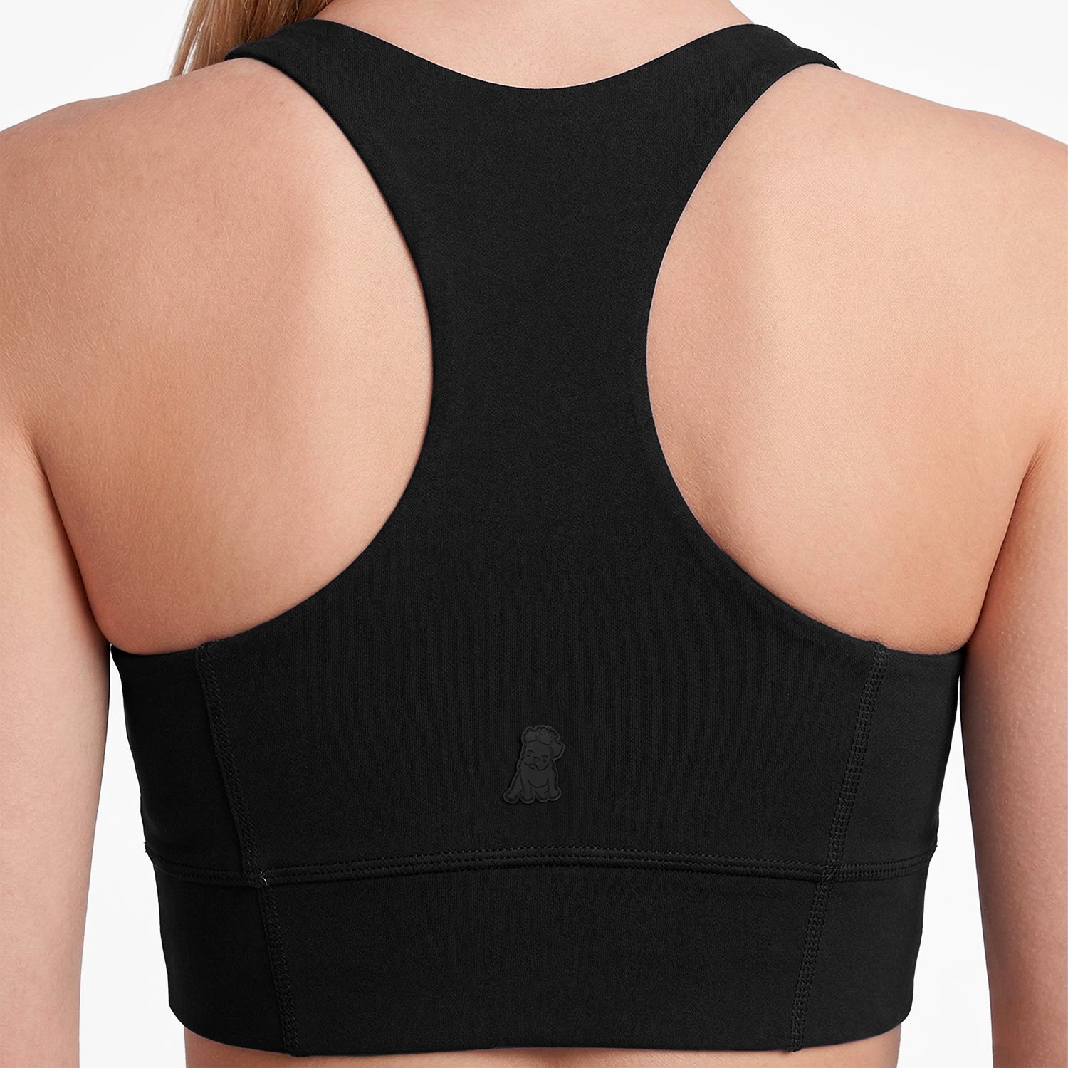 Black sports bra on a person with a plain background