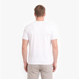 A man viewed from behind wearing a plain white short-sleeve crew-neck t-shirt