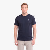 A man wearing a navy blue short-sleeve crewneck t-shirt with a small white embroidered logo