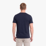 A man viewed from behind wearing a dark navy blue short-sleeve crewneck t-shirt