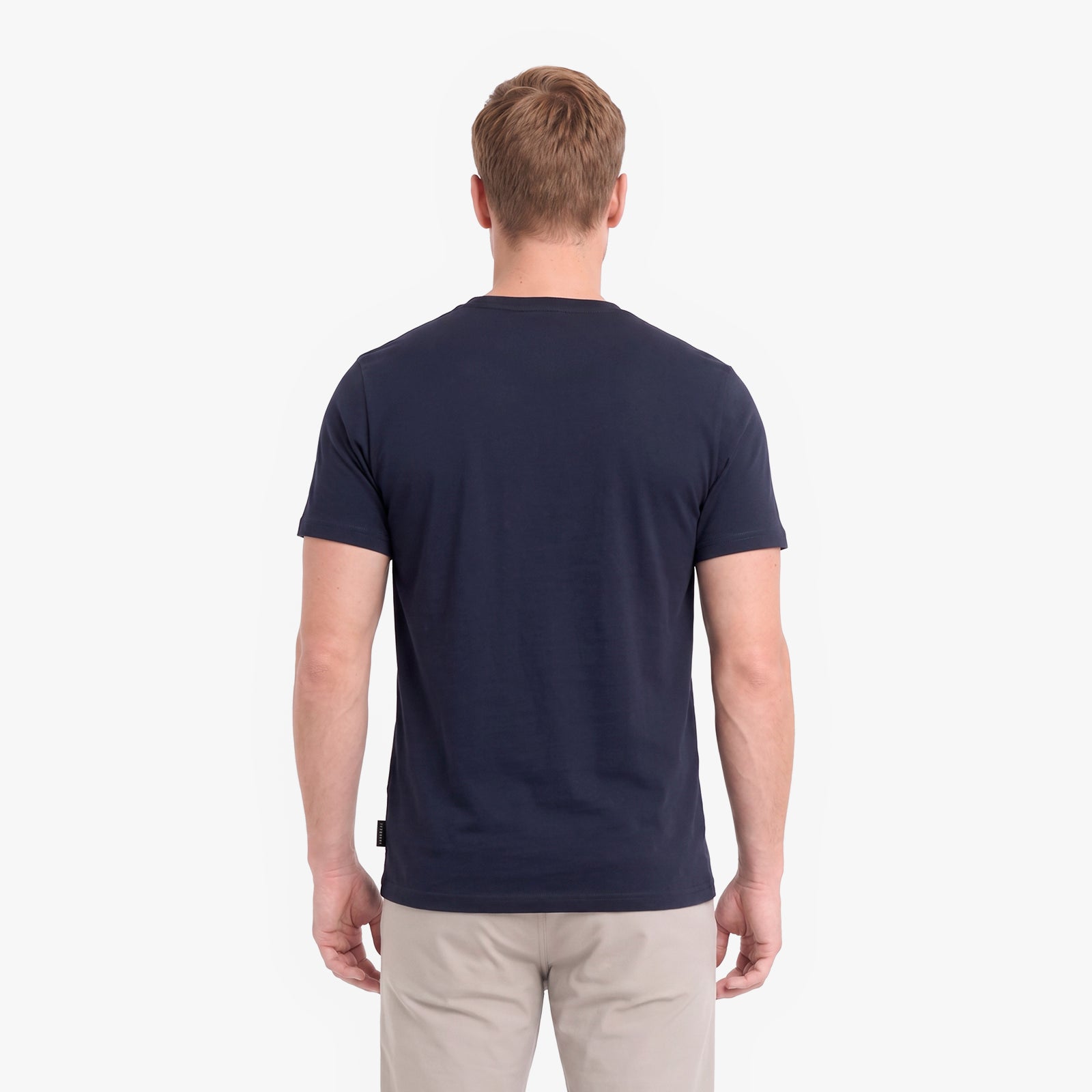 A man viewed from behind wearing a dark navy blue short-sleeve crewneck t-shirt