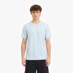 Person wearing a light blue t-shirt on a white background