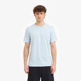 Person wearing a light blue t-shirt on a white background