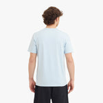 Person wearing a light blue t-shirt on a white background