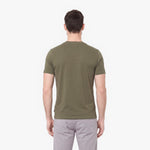 Man wearing an olive green t-shirt on a white background