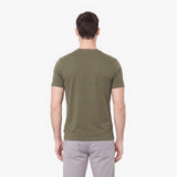Man wearing an olive green t-shirt on a white background