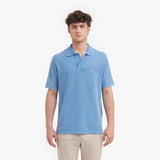 Man wearing a light blue polo shirt on a white background