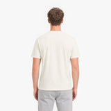 Man wearing a plain white t-shirt on a white background
